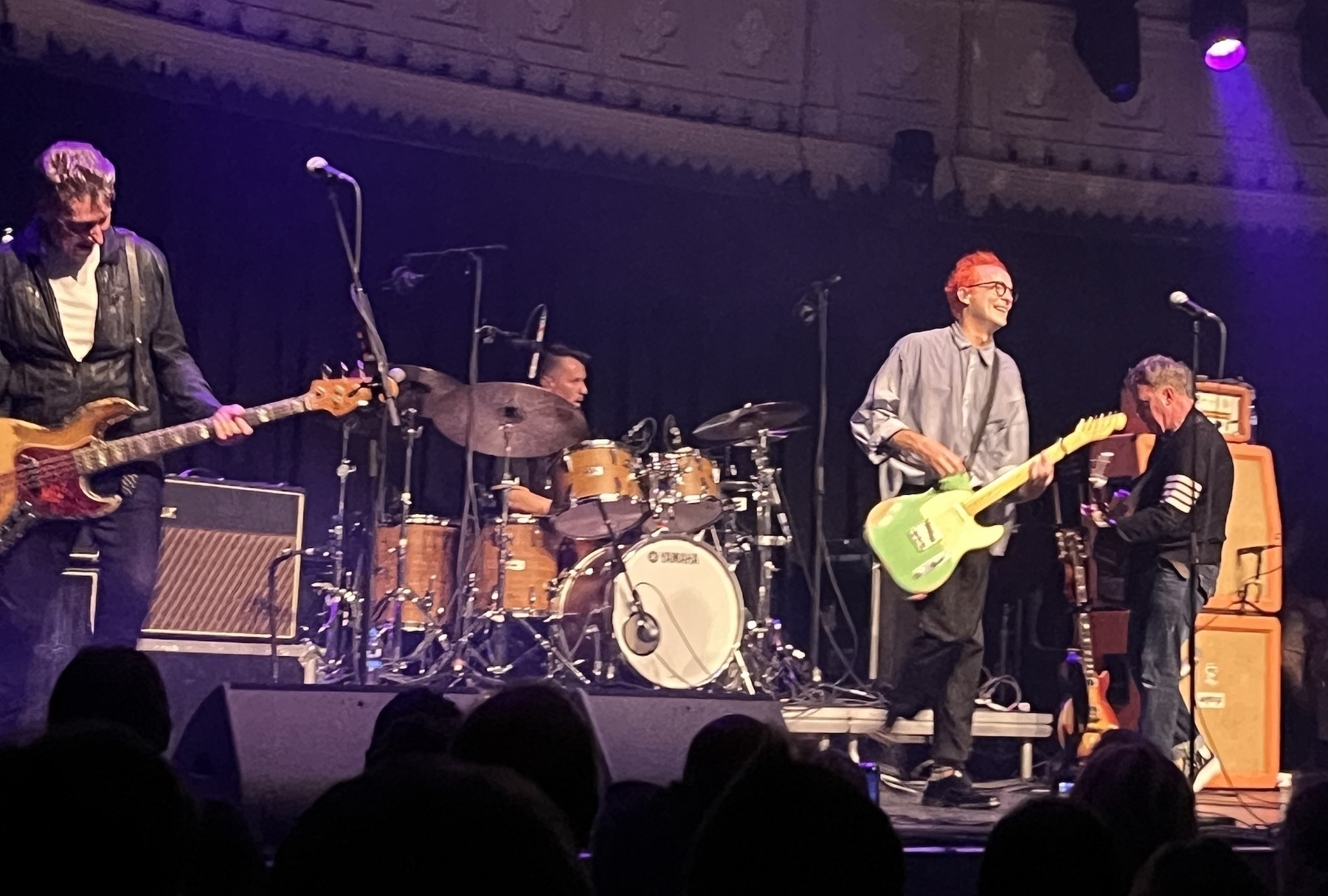 Four members of Travis standing on the stage at Paradiso, with lead singer with very orange dyed hair and another styled in fifties throwback Mark Lamar. All looking very happy with the first night of their tour.